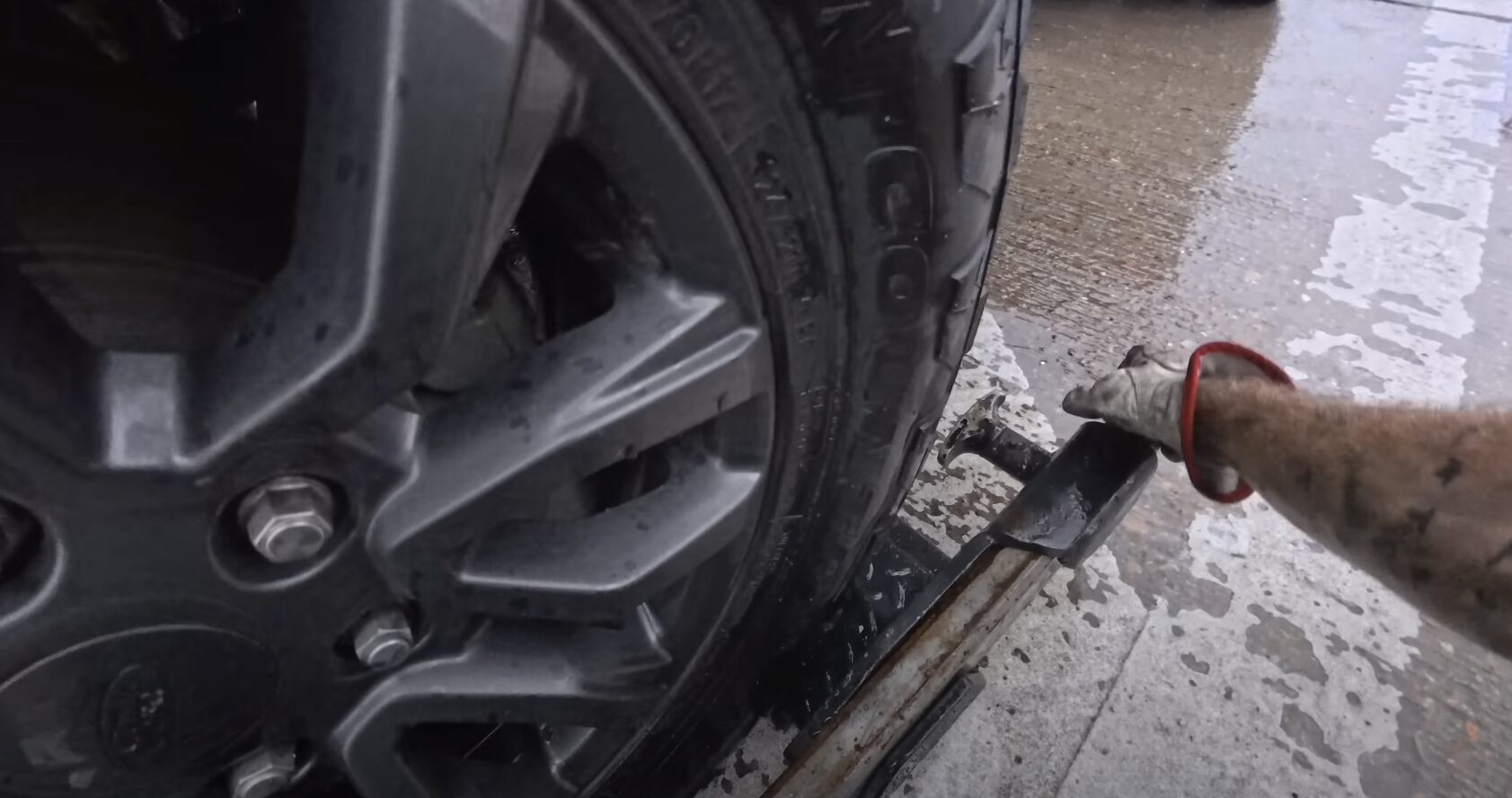 Professional Towing Equipment - Secure vehicle attachment for safe transport Close-up of car being secured to tow truck with professional towing straps and equipment